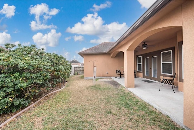 view of yard with ceiling fan and a patio area