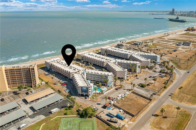 bird's eye view featuring a water view and a beach view