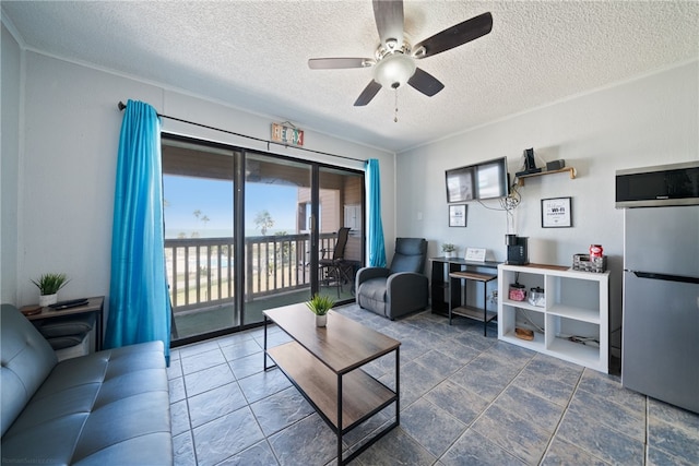 living room with a textured ceiling and ceiling fan