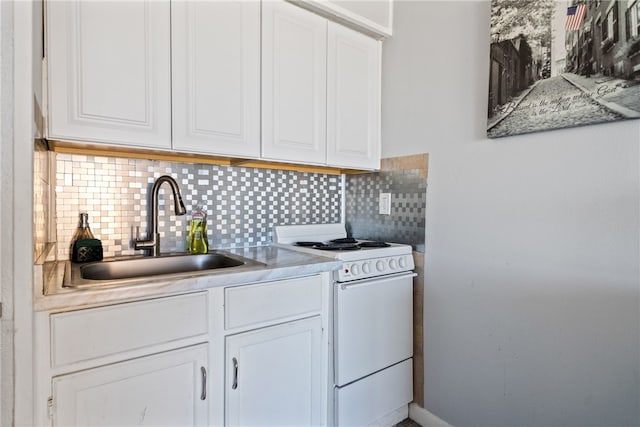 kitchen with white cabinetry, decorative backsplash, and white range oven