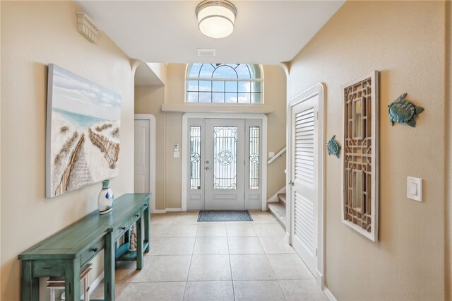 foyer entrance featuring light tile patterned flooring