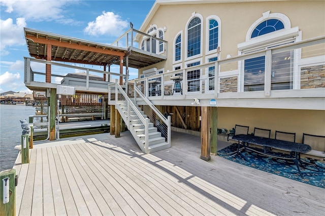 view of dock with a deck with water view