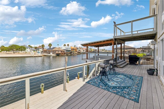 dock area with a deck with water view