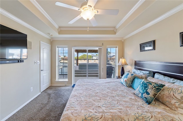 bedroom featuring access to outside, dark carpet, ornamental molding, ceiling fan, and a tray ceiling