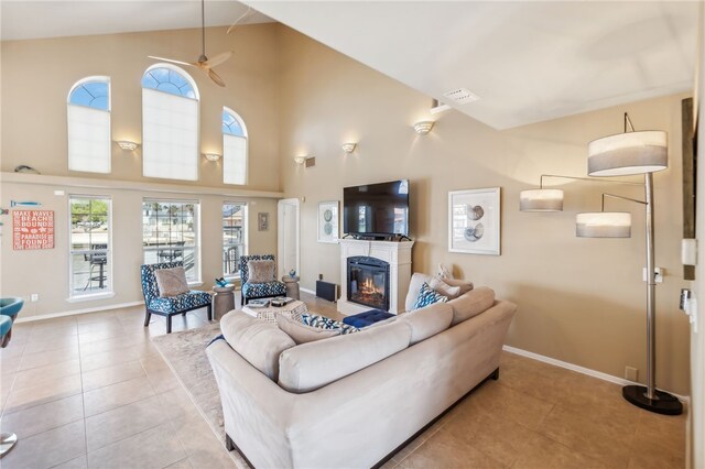 living room with high vaulted ceiling and light tile patterned floors