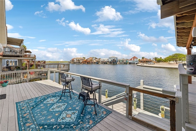 dock area featuring a water view and a balcony