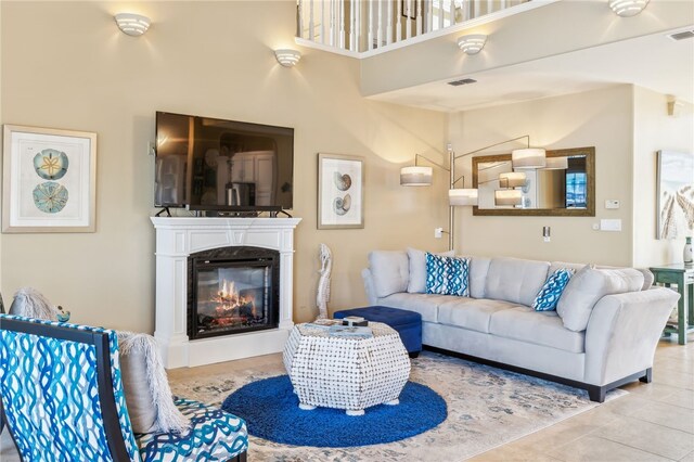 living room with tile patterned flooring and a high ceiling