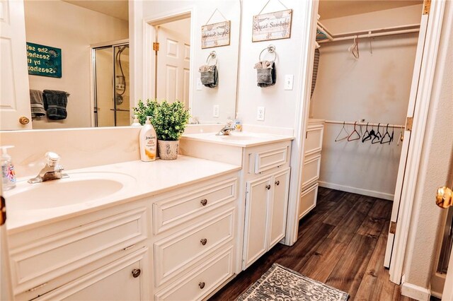 13965 Ports O Call Dr Unit D, Corpus Christi, TX 78418 - bathroom with wood finished floors, double vanity, a spacious closet, and a shower stall