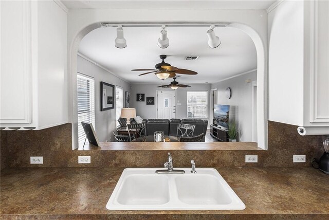 13965 Ports O Call Dr Unit D, Corpus Christi, TX 78418 - kitchen featuring arched walkways, ceiling fan, dark countertops, white cabinets, and ornamental molding