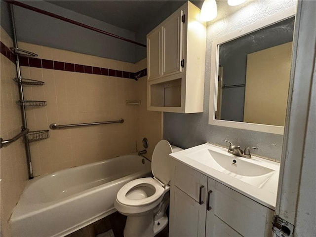 full bathroom with vanity, tiled shower / bath combo, and toilet