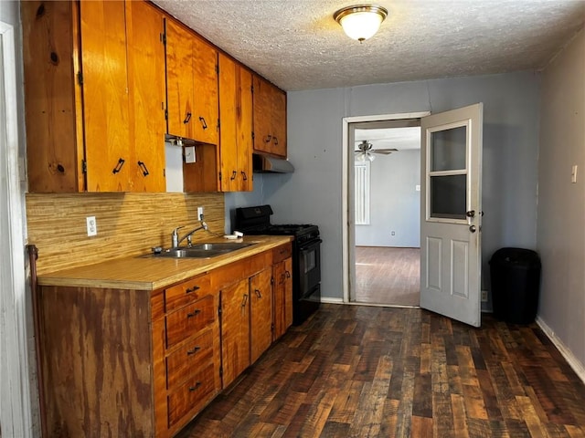 kitchen with extractor fan, dark hardwood / wood-style floors, sink, a textured ceiling, and black range with gas cooktop