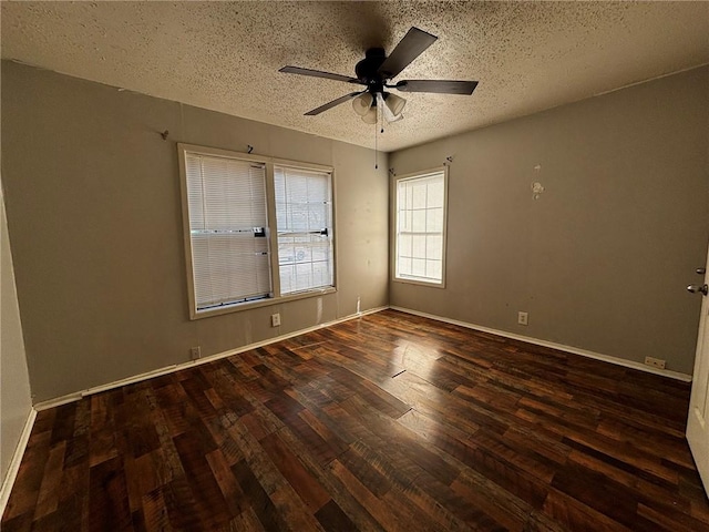 empty room featuring ceiling fan, a textured ceiling, and dark hardwood / wood-style flooring