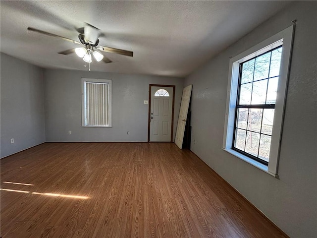 interior space featuring ceiling fan, hardwood / wood-style floors, and a textured ceiling