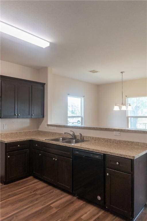 401 E Empresario St, Refugio, TX 78377 - kitchen featuring dishwasher, a sink, a peninsula, light countertops, and dark wood-type flooring