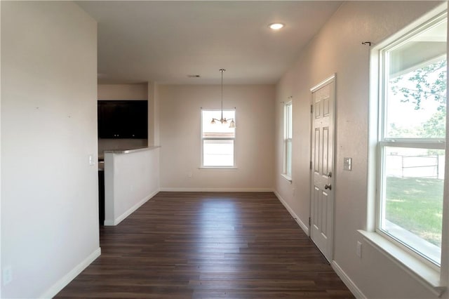 401 E Empresario St, Refugio, TX 78377 - unfurnished dining area featuring dark wood-style floors, healthy amount of natural light, baseboards, and recessed lighting