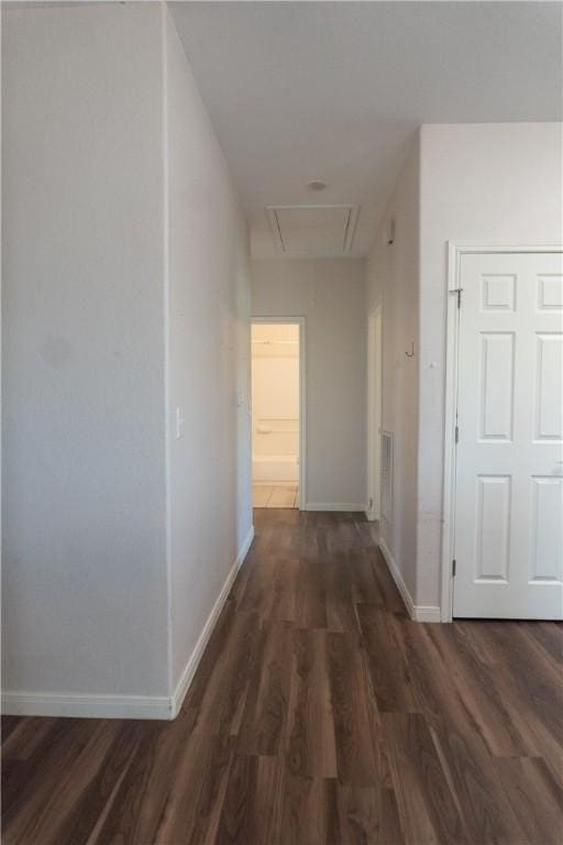 401 E Empresario St, Refugio, TX 78377 - corridor featuring attic access, wood finished floors, and baseboards