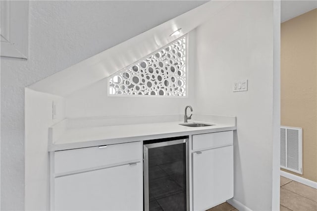 13731 Tajamar St, Corpus Christi, TX 78418 - indoor wet bar featuring wine cooler, light tile patterned floors, and baseboards