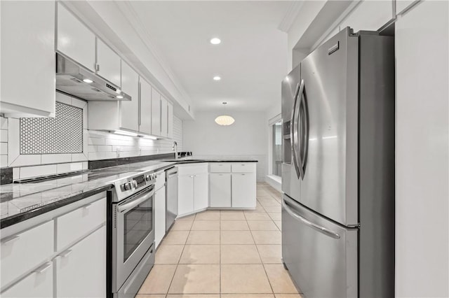 13731 Tajamar St, Corpus Christi, TX 78418 - kitchen featuring stainless steel appliances, a peninsula, white cabinets, a sink, and tasteful backsplash
