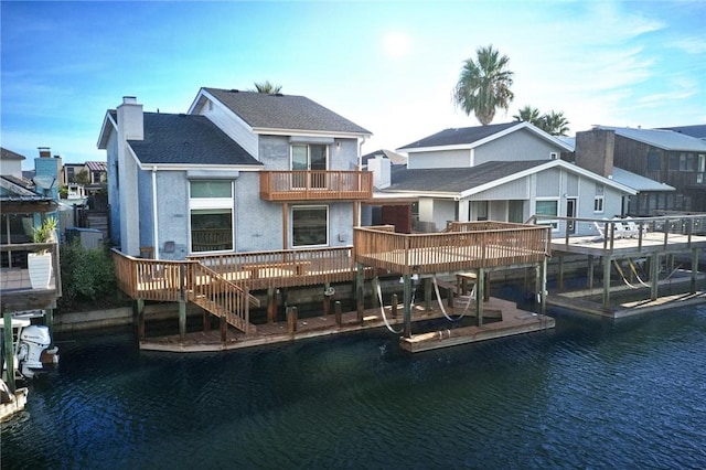 13731 Tajamar St, Corpus Christi, TX 78418 - rear view of house with a water view, a chimney, a shingled roof, and a balcony