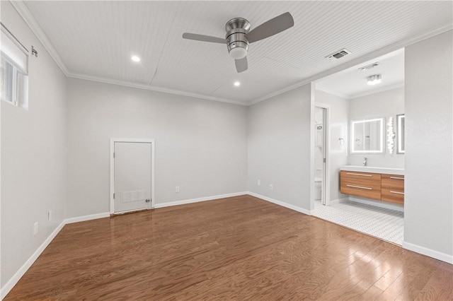 13731 Tajamar St, Corpus Christi, TX 78418 - unfurnished bedroom with wood finished floors, ornamental molding, recessed lighting, multiple windows, and a sink