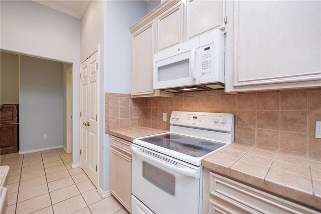 3829 Brockhampton Ct, Corpus Christi, TX 78414 - kitchen with white appliances, tile countertops, backsplash, and light tile patterned floors