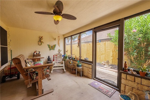 3829 Brockhampton Ct, Corpus Christi, TX 78414 - sunroom featuring ceiling fan, wooden walls, and unfinished concrete flooring