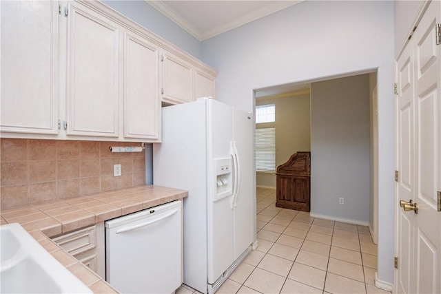 3829 Brockhampton Ct, Corpus Christi, TX 78414 - kitchen with white appliances, tile countertops, tasteful backsplash, crown molding, and light tile patterned flooring