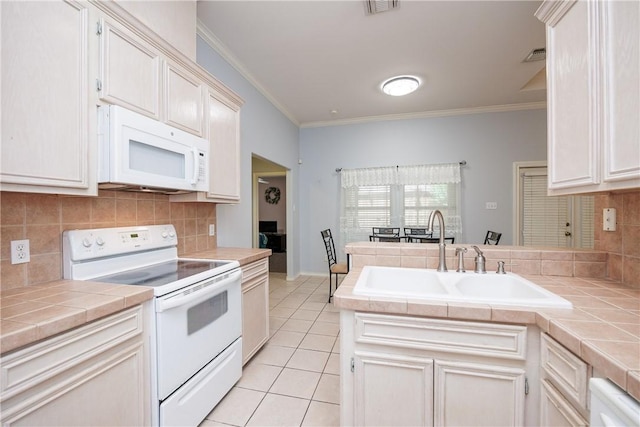 3829 Brockhampton Ct, Corpus Christi, TX 78414 - kitchen featuring white appliances, tile counters, ornamental molding, tasteful backsplash, and light tile patterned floors