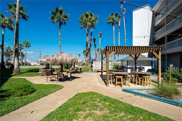 view of property's community featuring a patio area and a lawn