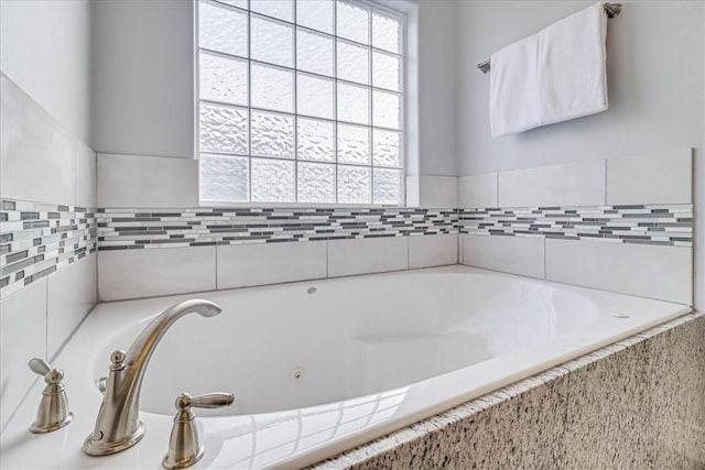 bathroom featuring tiled bath