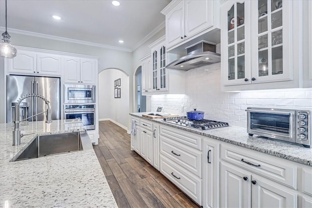 kitchen with decorative light fixtures, white cabinetry, appliances with stainless steel finishes, and tasteful backsplash