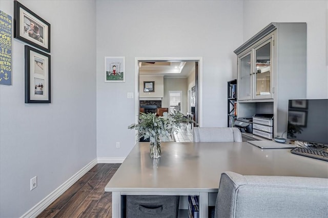 home office featuring crown molding and a fireplace