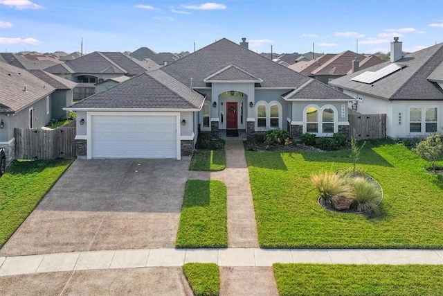 view of front facade with a front yard and a garage