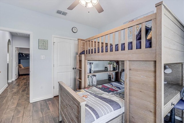 bedroom featuring ceiling fan and dark wood-type flooring