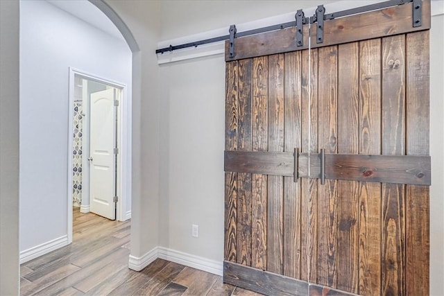 details with hardwood / wood-style flooring and a barn door