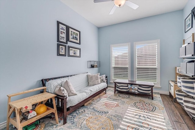 living room featuring ceiling fan and dark hardwood / wood-style floors