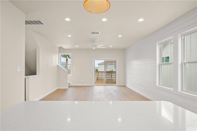 interior space with light wood-type flooring, visible vents, and recessed lighting