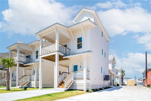 view of front of home featuring driveway, board and batten siding, and a residential view