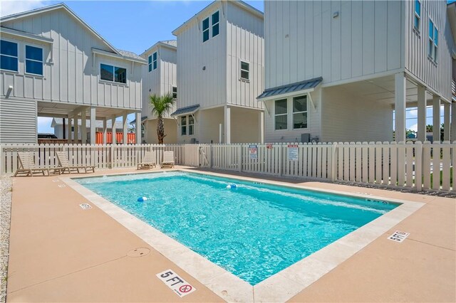 community pool featuring a patio area and fence