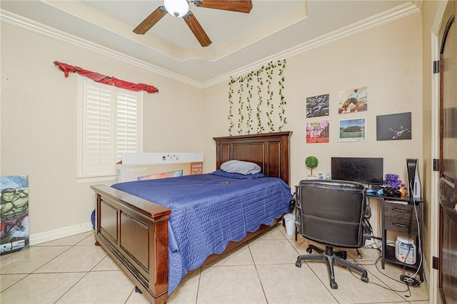 bedroom featuring a ceiling fan, a tray ceiling, crown molding, light tile patterned floors, and baseboards