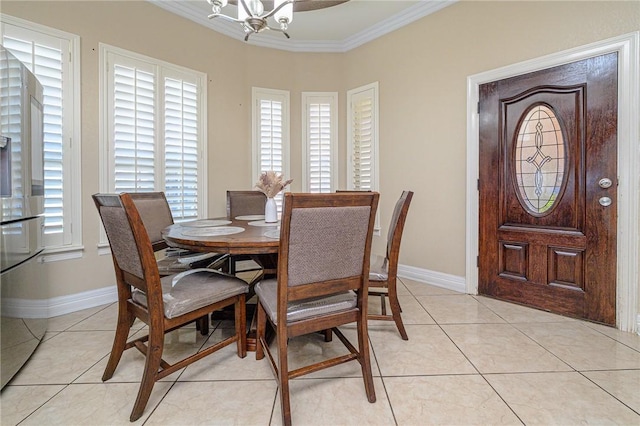 dining space with crown molding, a notable chandelier, light tile patterned flooring, and baseboards