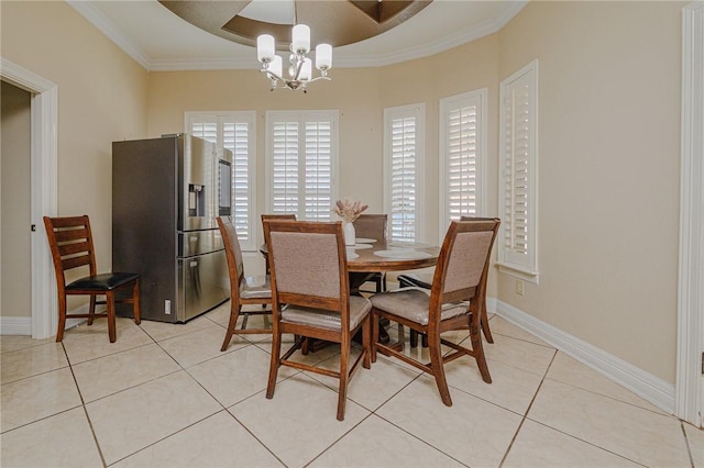 dining space with crown molding, a notable chandelier, light tile patterned flooring, and baseboards