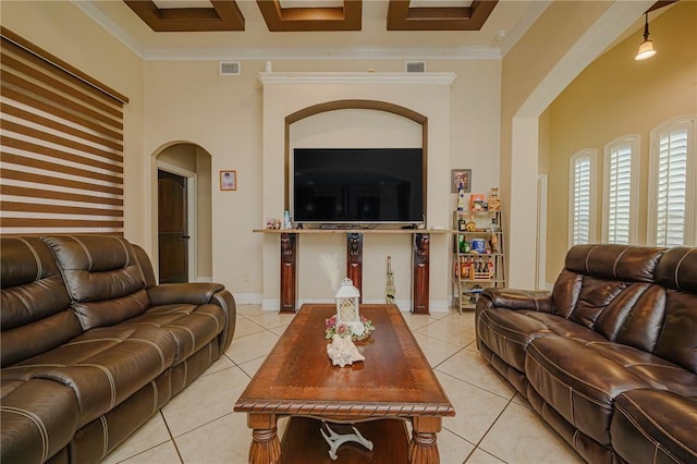 living room featuring light tile patterned floors, visible vents, arched walkways, and ornamental molding