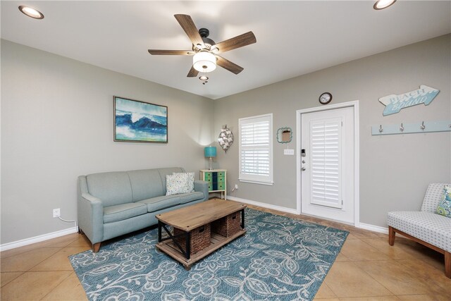 tiled living room with ceiling fan