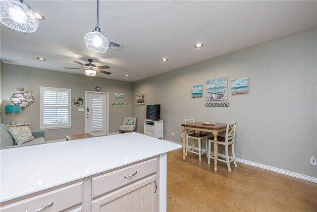 kitchen with pendant lighting, ceiling fan, and light brown cabinets