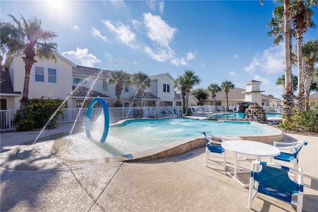 view of pool featuring pool water feature and a patio area