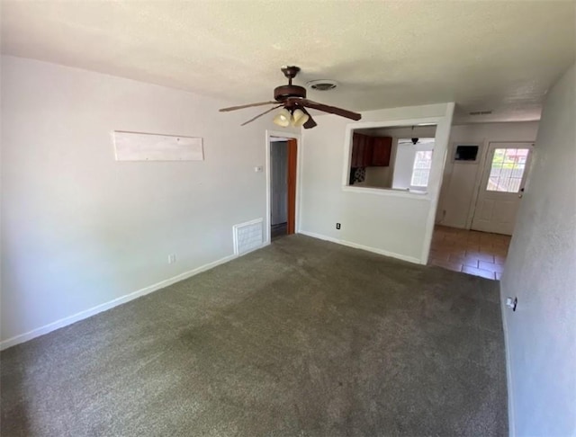 carpeted spare room featuring a textured ceiling