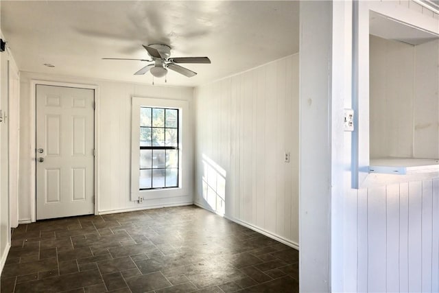 foyer featuring ceiling fan, radiator heating unit, and wooden walls