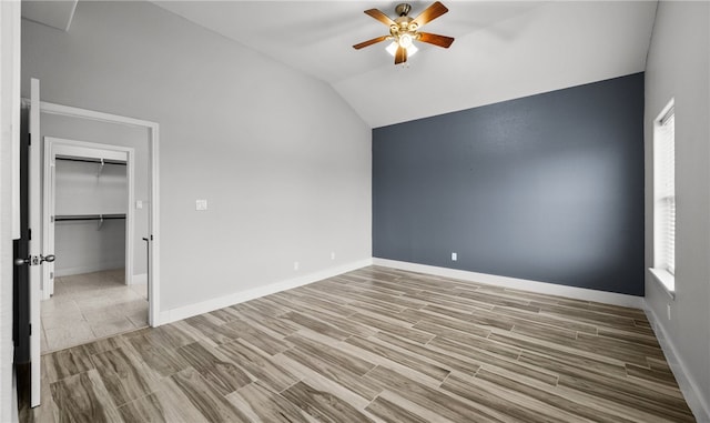 interior space with ceiling fan, a closet, light wood-type flooring, and lofted ceiling