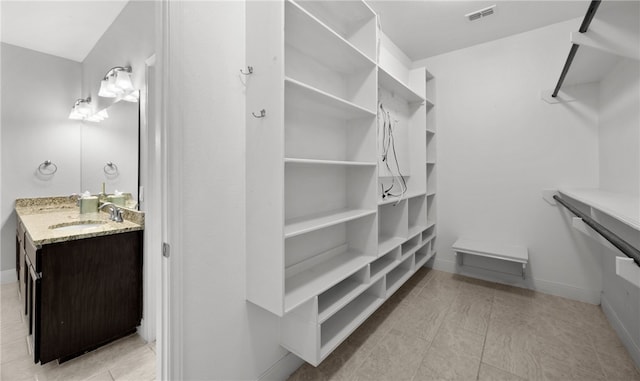 walk in closet featuring sink